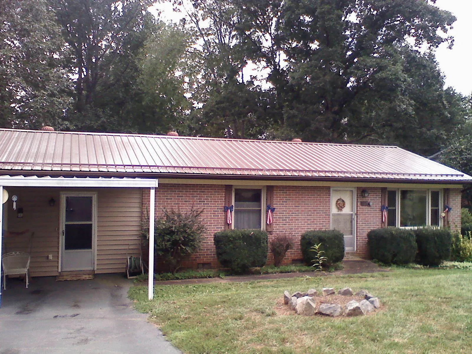 Bronze metal roof and carport on a brick ranch home — Roof Repair work by our crew in Morenci